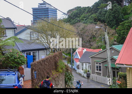 Emplacement du logement résidentiels à forte pente à Wellington en Nouvelle-Zélande avec l'homme et l'enfant marche sur la route escarpée. Banque D'Images