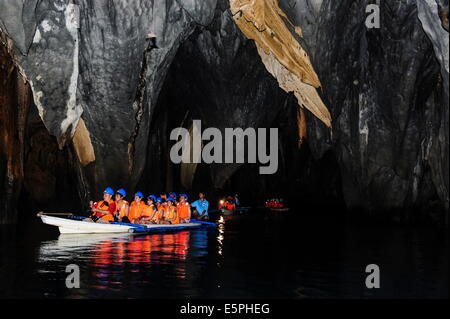 Les touristes dans un bateau à rames entrant dans la rivière souterraine, Puerto-Princesa River National Park, site de l'UNESCO, Philippines Banque D'Images