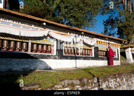 Le moine bouddhiste en tournant les roues de prière contemplative dans la prière du matin, monastère bouddhiste de Tawang, Arunachal Pradesh, Inde Banque D'Images