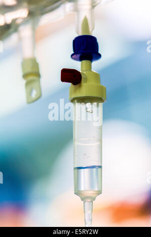 Close-up de la chambre compte-gouttes d'une perfusion intraveineuse (IV) relié à un patient subissant une chirurgie. Banque D'Images