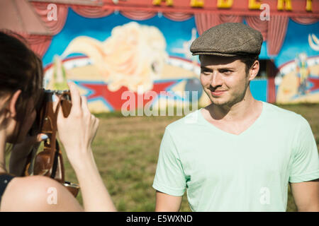 Jeune couple photographing on fête foraine à appareil photo reflex Banque D'Images