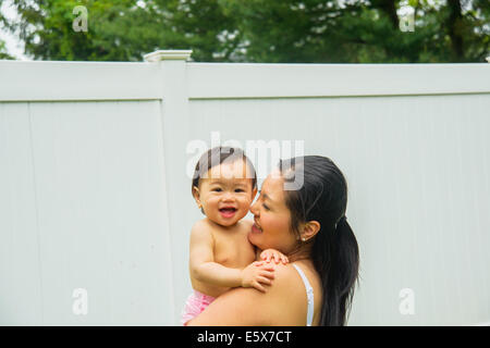 Portrait of mid adult mother and baby boy in garden