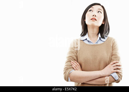 Close up portrait of young woman with arms folded Banque D'Images