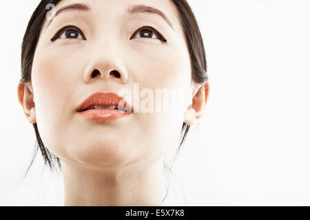 Close up portrait of young woman looking up Banque D'Images