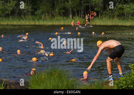 Les gens participant à un swimrun Ångaloppet, compétition où vous exécutez sur terre et se baigner dans les lacs et la mer à plusieurs reprises. Banque D'Images