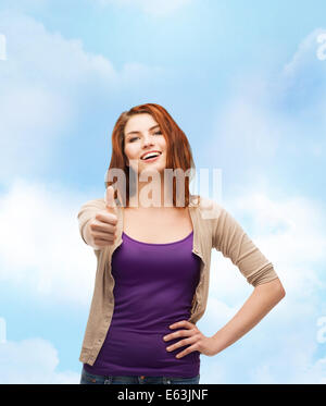 Smiling girl in casual clothes showing Thumbs up Banque D'Images