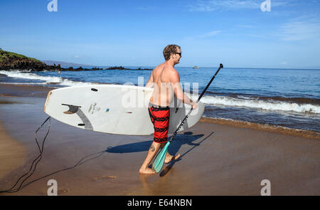 Homme avec stand up paddleboard à plage de Wailea, Maui Banque D'Images