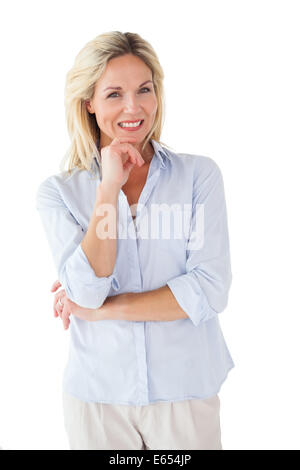 Happy blonde posing with hand on chin Banque D'Images