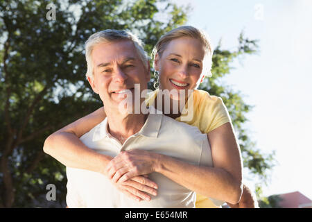 Happy senior man giving son partenaire un piggy back Banque D'Images