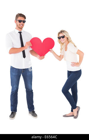 Cool young couple holding red heart Banque D'Images