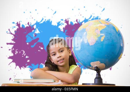 Image composite de cute pupils sitting at desk Banque D'Images