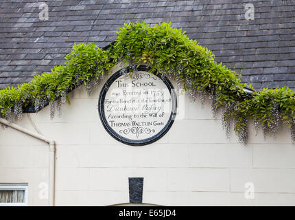 Un panneau ou une plaque gravée dans une école qui a été érigée en 1759 à Dunham Massey Altrincham Greater Manchester Angleterre Cheshire Banque D'Images