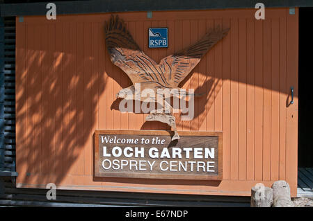 Panneau de Bienvenue sur la porte coulissante en bois avec des sculptures sur bois d'Osprey battant avec des poissons, RSPB Loch Garten Osprey Centre, Cairngorms Banque D'Images