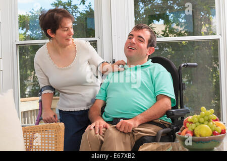 Couple avec la paralysie cérébrale assis sur leur deck Banque D'Images