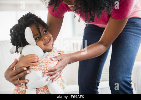 Girl hugging stuffed animal Banque D'Images