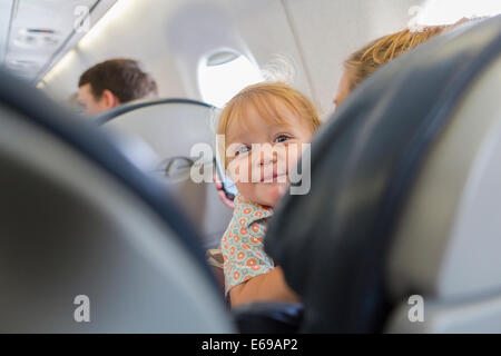 Caucasian baby laughing on airplane Banque D'Images