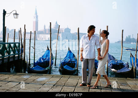 Couple holding hands on urban Canal, Venice, Veneto, Italie Banque D'Images