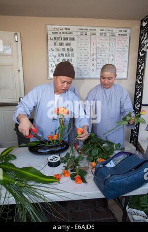 Les moines bouddhistes, faisant des arrangements de fleurs, Vietnamien funérailles, Little Saigon, ville de Westminster, Californie, Banque D'Images