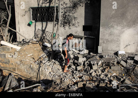 La bande de Gaza. 20e Août, 2014. Inspecter les Palestiniens leur maison qui a été endommagée lors d'une attaque aérienne israélienne dans la ville de Gaza. Le Hamas dans la bande de Gaza ont tiré des roquettes sur Israël après la reprise des combats lors de la trêve est terminée. Credit : Ahmed Hjazy/Pacific Press/Alamy Live News Banque D'Images