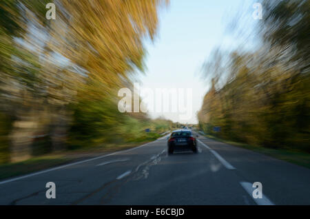 Voiture roulant sur une route de campagne Banque D'Images