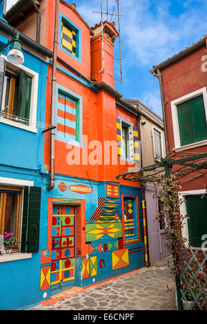 Maison peintes de couleurs vives avec des conceptions sur l'île de Burano, dans la lagune de Venise. Banque D'Images