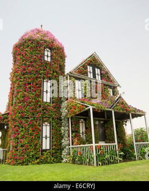 Floral spectaculaire display, maison créée avec des masses de fleurs rouge et vert le feuillage à Dubaï Miracle Jardins en désert de l'eau Banque D'Images