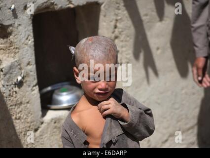 Kaboul, Afghanistan. 21e Août, 2014. Un enfant afghan se trouve à l'extérieur d'une tente dans un camp de personnes déplacées à Kaboul, en Afghanistan, le 21 août 2014. Credit : Ahmad Massoud/Xinhua/Alamy Live News Banque D'Images