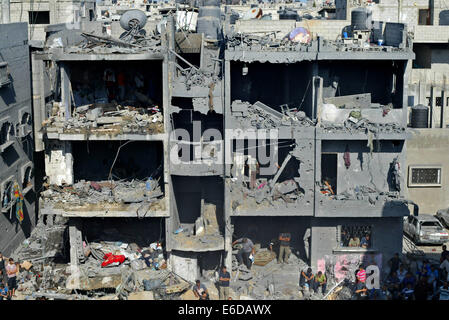 La bande de Gaza. 21e Août, 2014. Les Palestiniens à l'intérieur d'un bâtiment détruit rassemble, après le Hamas affirme que trois de ses officiers supérieurs qui ont été identifiés comme Mohammed Abu Shamaleh, Raed Attar et Mohammed Barhoum qui ont été tués par des frappes aériennes israéliennes à Tel es-Sultan près de Rafah. Credit : Ibrahim Khatib/Pacific Press/Alamy Live News Banque D'Images