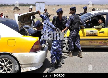 Sanaa, Yémen. 21e Août, 2014. Des soldats yéménites guard un point de contrôle et vérifier les voitures à une entrée à Sanaa, Yémen, le 21 août 2014. L'armée yéménite le jeudi les soldats déployés à toutes les entrées de la capitale, Sanaa pour maintenir la sécurité alors que des milliers de combattants Houthi chiites se rassemblent autour de Sanaa pour réclamer la démission du gouvernement. © Mohammed Mohammed/Xinhua/Alamy Live News Banque D'Images