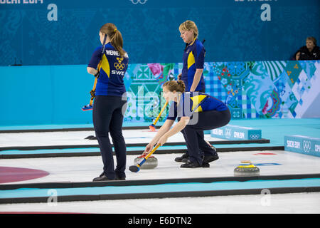 Christina Bertrup (C) joue une pierre avec Maria Prytz (R) et Maria Wennerstroem balayant de la Suède au cours de l'équipe de curling Banque D'Images