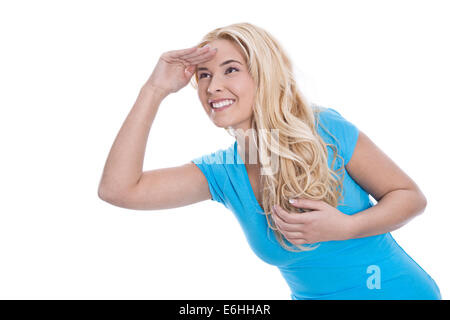 Young pretty smiling woman isolated over white à la recherche dans ses futures portant chemise turquoise. Banque D'Images