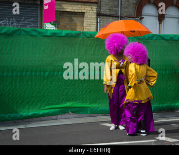 Londres, Royaume-Uni. 24 août, 2014. Deux dames en violet afro perruques et costumes colorés pause avant de prendre part au défilé du Carnaval : Crédit photographique à vue/Alamy Live News Banque D'Images
