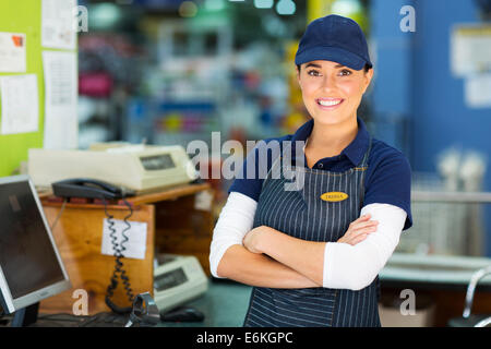 Happy female hardware store cashier with arms folded Banque D'Images