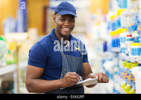 Happy African shop assistant contrôle de stock en supermarché Banque D'Images