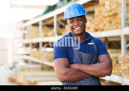 Handsome African Male warehouse worker with arms crossed Banque D'Images