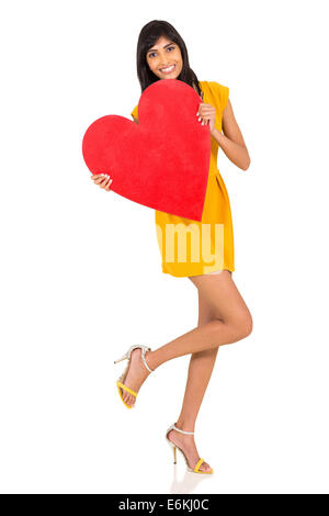 Cheerful Indian girl with heart shape against white background Banque D'Images