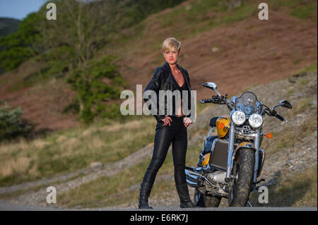 Une femme posant avec une puissante moto Triumph Rocket III pour un "biker chick / chic' séance photo relooking UK Banque D'Images