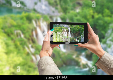 Girl taking photos sur une tablette dans le parc national des Lacs de Plitvice en Croatie Banque D'Images