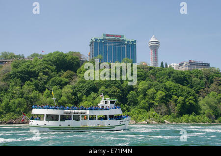 New York, USA & Canada, Ontario, Niagara. Niagara Falls, Maid of the Mist boat avec les chutes du Niagara et l'hôtel Sheraton. Banque D'Images