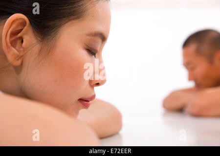 Young Asian Woman and man relaxing in gym Banque D'Images