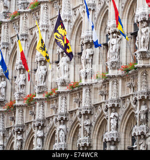 Drapeaux du monde sur l'affichage contre l'extérieur de l'impressionnant hôtel de ville gothique du 15ème siècle à Leuven (Louvain), Belgique Banque D'Images