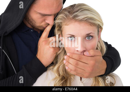 Vol couvrant la bouche de jeune femme Banque D'Images