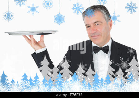 Image composite de welldressed waiter holding a silver tray Banque D'Images