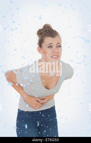 Image composite de femme souffrant de douleurs de menstruation Banque D'Images