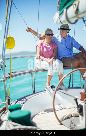 Couple sitting in même bateau sur l'eau Banque D'Images