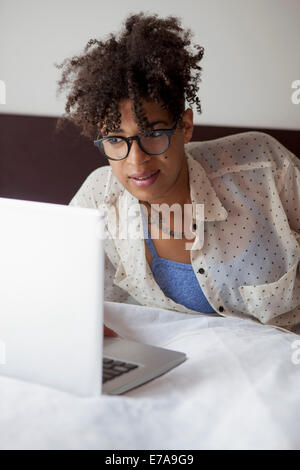 Woman on bed at home Banque D'Images