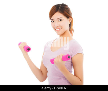 Young woman working out with dumbbells dans ses mains Banque D'Images