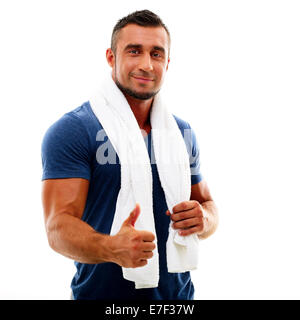 Portrait of a happy sportsman avec serviette showing thumb up Banque D'Images