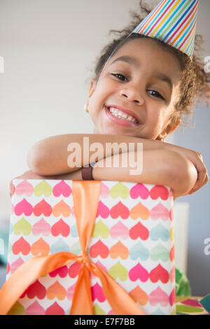 African American girl holding enveloppé cadeau anniversaire Banque D'Images