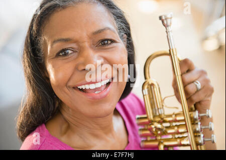 Mixed Race woman holding trumpet Banque D'Images
